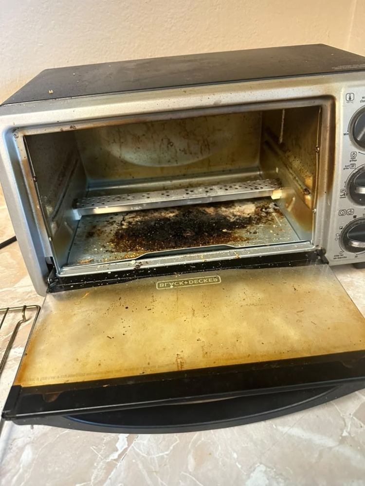 Oven before cleaning by Amanda’s Elite Services